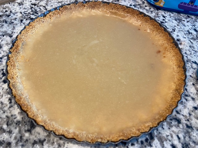 Butterscotch tart after it's been in the fridge overnight. It's a frosty, tan color. It's opaque.