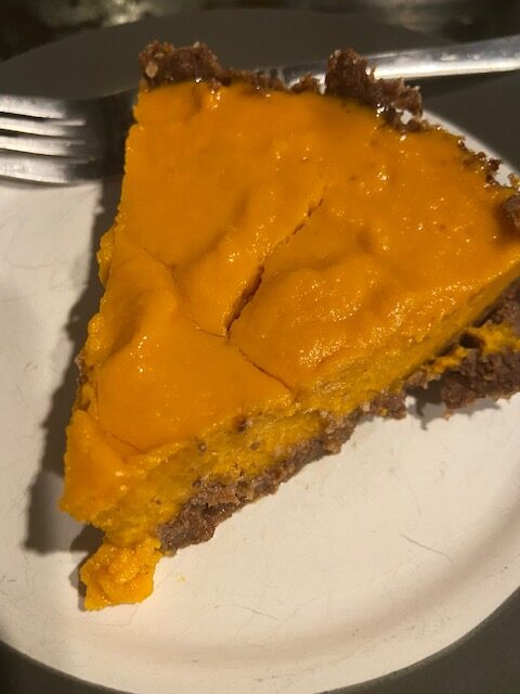 Slice of sweet potato pie with chocolate hazelnut crust